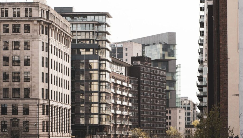 a bridge over a river with buildings in the background